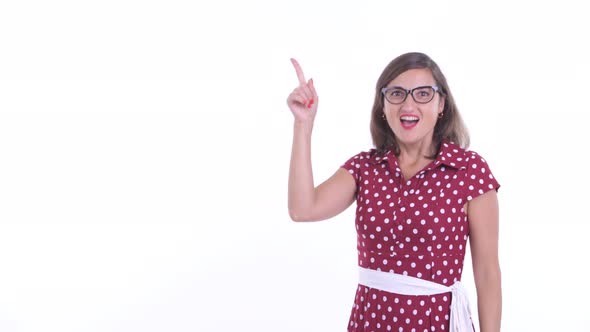 Happy Beautiful Woman with Eyeglasses Pointing Up and Looking Surprised