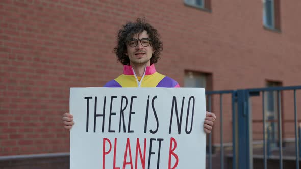 Young Guy Holding Banner with Phrase There is No Planet B