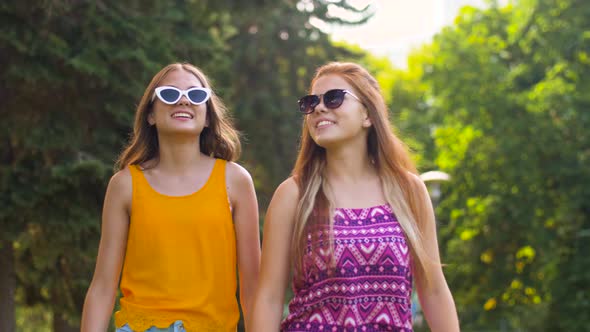 Teenage Girls or Friends Walking in Summer Park