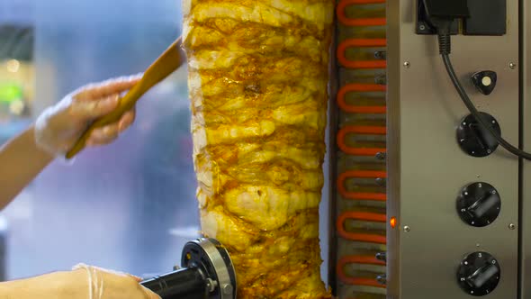 Chef Slicing Doner Meat From Spit at Kebab Shop 7