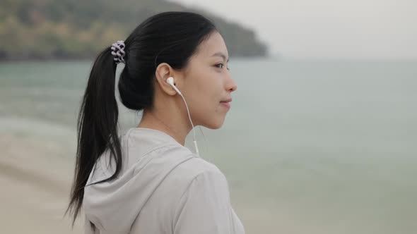 Happy beautiful athlete female wearing sportswear and listening to music.