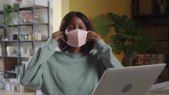 A Beautiful Lady is Putting a Protective Mask on Her Face