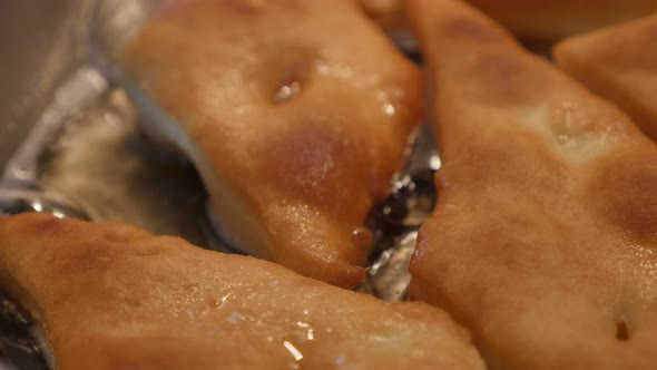 Frying pan with pirozhki made of dough close-up 3840X2160 UltraHD footage - Preparing of tasty fried
