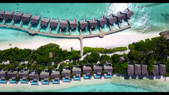 Aerial drone shot sky of tranquil coast beach journey by turquoise ocean with white sandy background