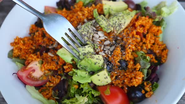 Fresh Vegetable Salad With Hummus And Falafel On Wooden Background