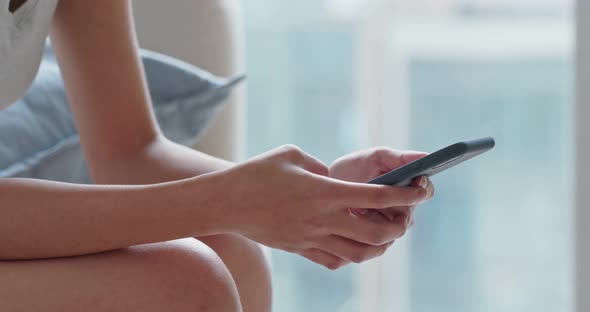 Woman use of mobile phone at home