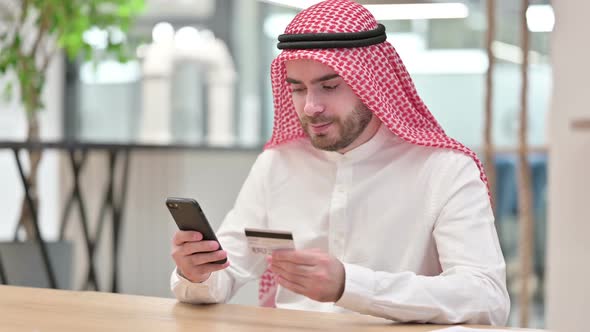 Arab Businessman with Successful Online Payment on Smartphone in Office