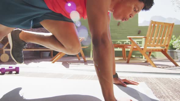 Fit african american man exercises with his front support at home