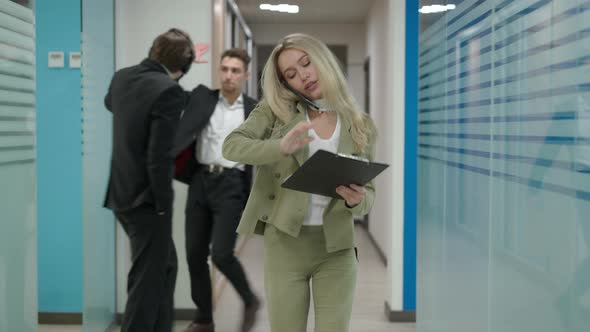 Portrait of Busy Serious Confident Beautiful Female CEO Walking in Office Hallway Talking on the