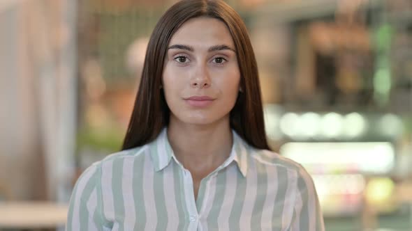 Portrait of Smiling Young Latin Woman Looking at Camera