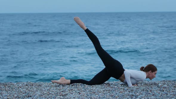 Fitness Outdoors  a Woman Stretching By the Blue Sea