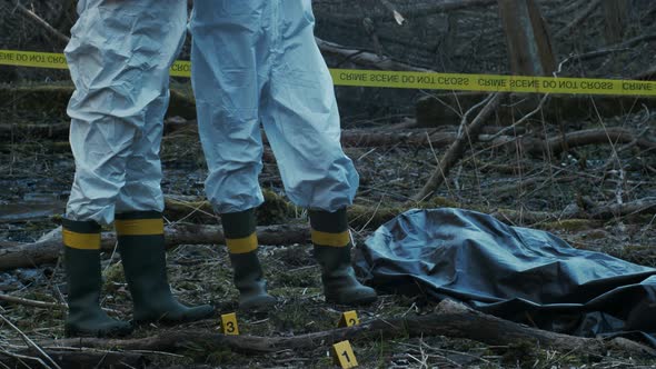 Forensic specialists working in the forest. Crime scene and police concept.