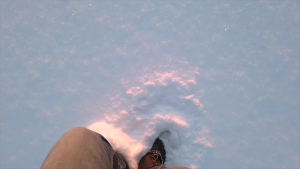 Legs of Man and Snow in Sunlight