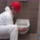 Professional Worker Man Hanging Heavy Toilet Bowl Pan in New Modern Bathroom - VideoHive Item for Sale