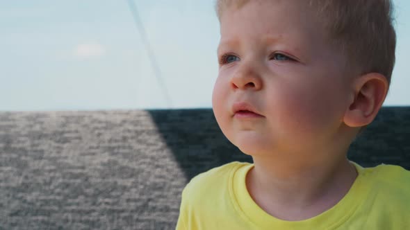 Somnolent Toddler Boy in Yellow Tshirt Yawns in Ropeway Car