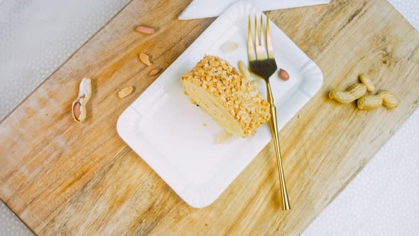 Peanut Roll Cake on a Plate with a Gold Fork