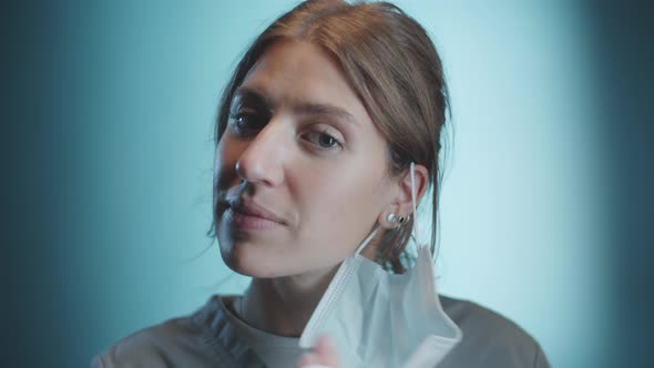 Female Doctor Removing Medical Mask and Posing for Camera