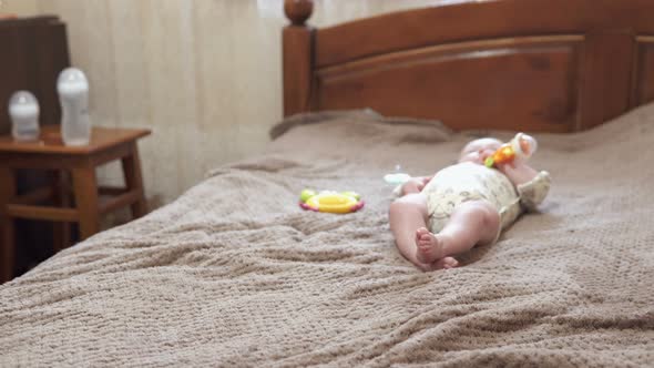 A newborn baby sleeps in a crib.