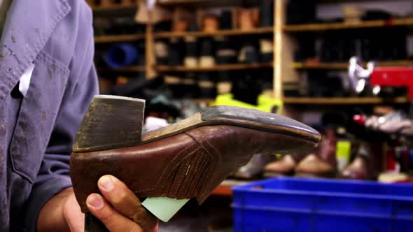 Cobbler hammering on shoe sole