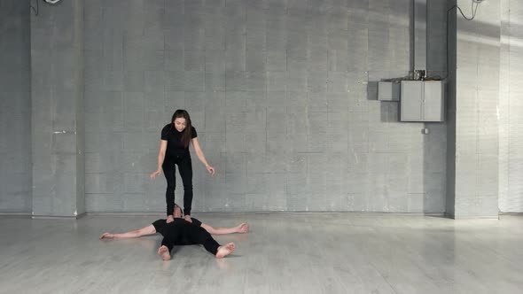 Young Couple of Dancers Training in Studio