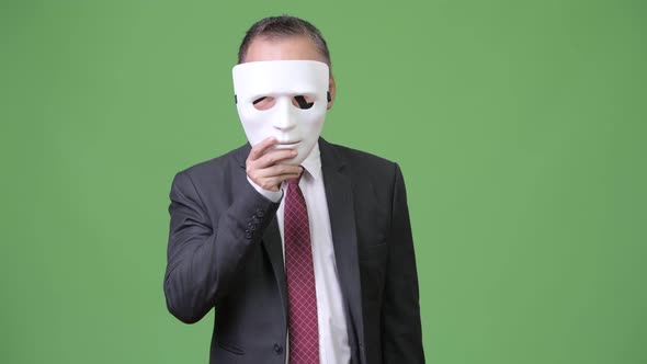 Mature Japanese Businessman with White Mask As Concept