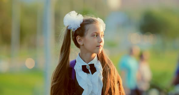 Closeup Portrait of an Elementary School Student Walking Through the Park