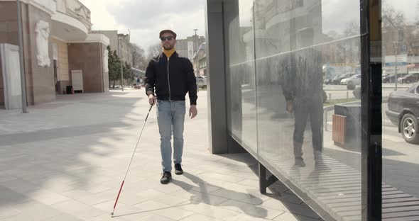 Blind Man Walking Alone in the City
