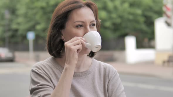 Outdoor Sitting Old Woman Drinking Coffee