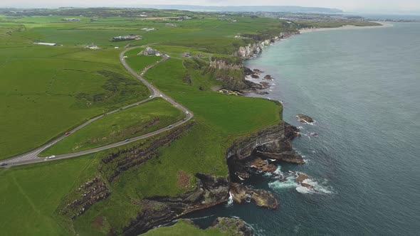 Ireland Ocean Coastal Meadows Aerial View Road with Cars at Green Landscape