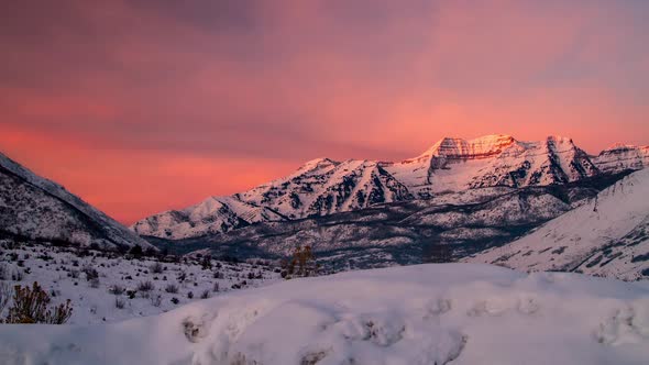 Time Lapse of Snow Covered Mountain at Sunrise.