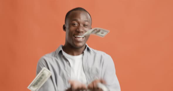 Happy Rich Black Guy Throwing Out Money Bills and Dancing