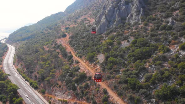 Close-up Flight Next To the Uphill Funicular with the Coast in the Background 