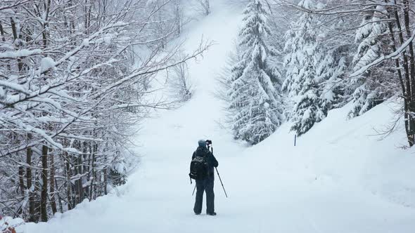 The Photographer Shoot a Mountain Forest in the Carpathians in Rainy and Snowy Weather