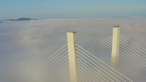 Tops of the Pylons of the Golden Bridge in the Dawn Fog in Vladivostok