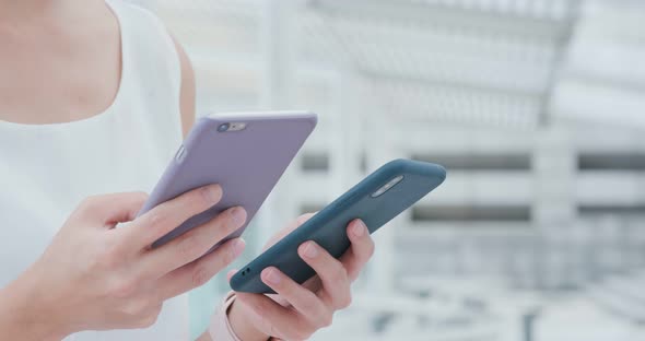 Woman sending data between mobile phone