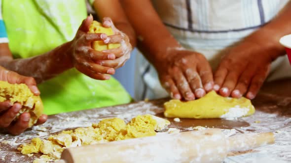 Multi-generation family preparing dessert in kitchen