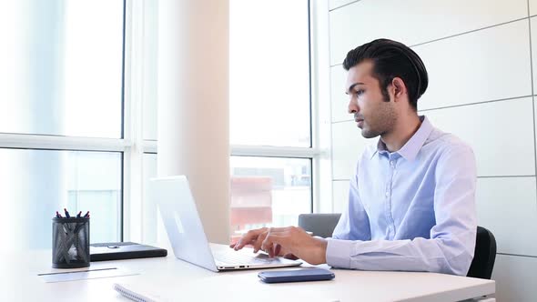 Young indian businessman using smart phone