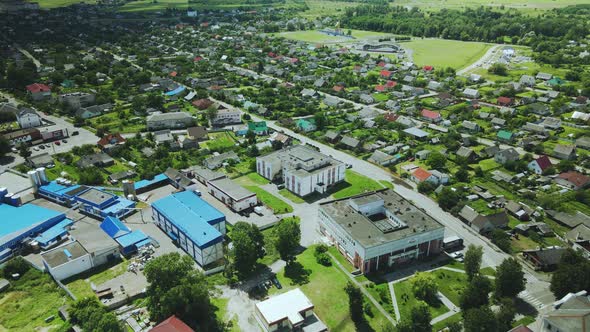 Flight over a provincial town. Multi-colored roofs of houses are visible. Aerial photography.