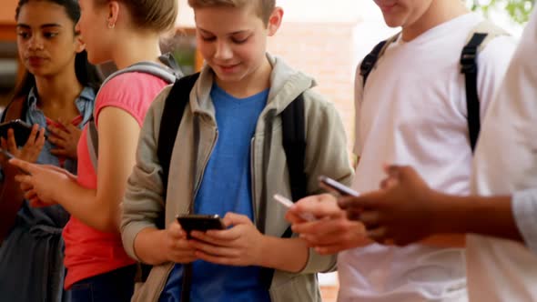 Group of school friends using mobile phone 4k