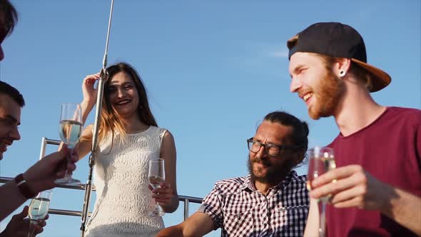 A Company of Young Friends Enjoys Celebrating a Birthday on Yacht in the Daytime