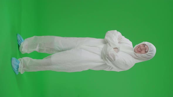 Full Body Of Asian Male Wear Uniform Ppe Pose With Arms Crossed In Green Screen Studio