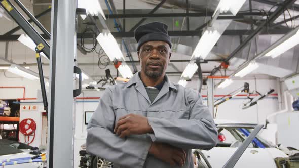 African American male car mechanic crossing his arms and looking at camera