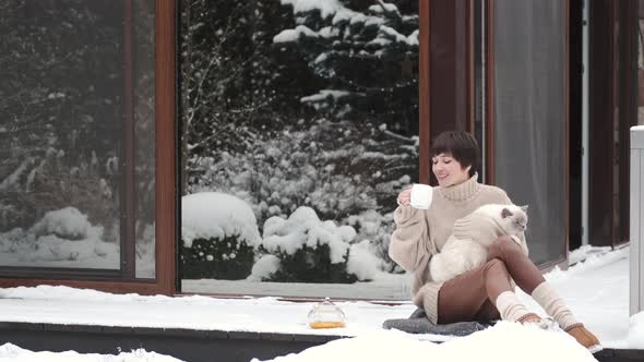 Peaceful Young Woman Drink Tea on Home Terrace in Winter