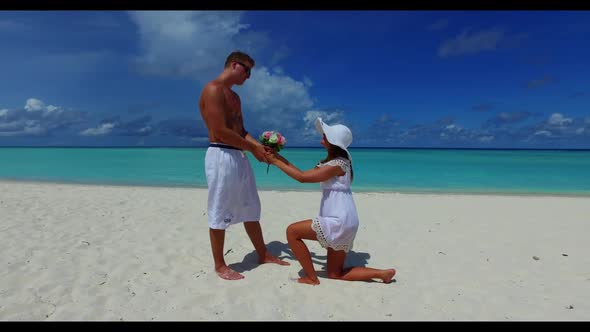 Man and lady happy together on relaxing island beach wildlife by shallow water with white sandy back