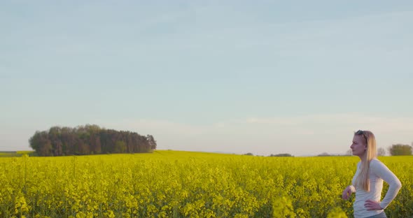 Young Farmer Using Digital Tablet at Oilseed Rape Field