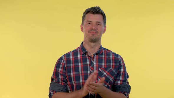 Close-up of Handsome Man in Checkered Shirt Clapping His Hands