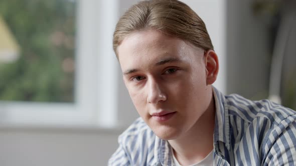 Portrait of Young Handsome Caucasian Man Looking at Camera with Serious Facial Expression