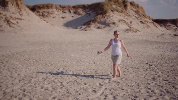 Young Woman Walking at Beach in Summer