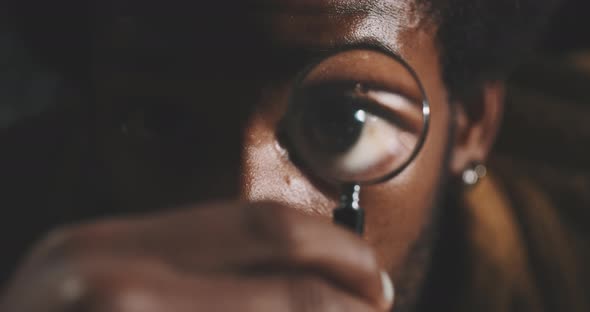 Close up of a man with a hand lens