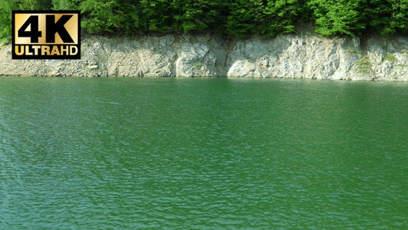 Water waves at the foot of the mountain